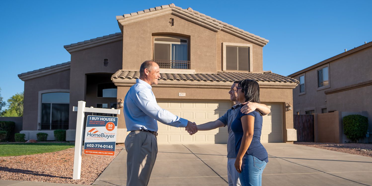 Young couple shaking hands with CEO of Trusted Homebuyer because they are buying a house that they wanted