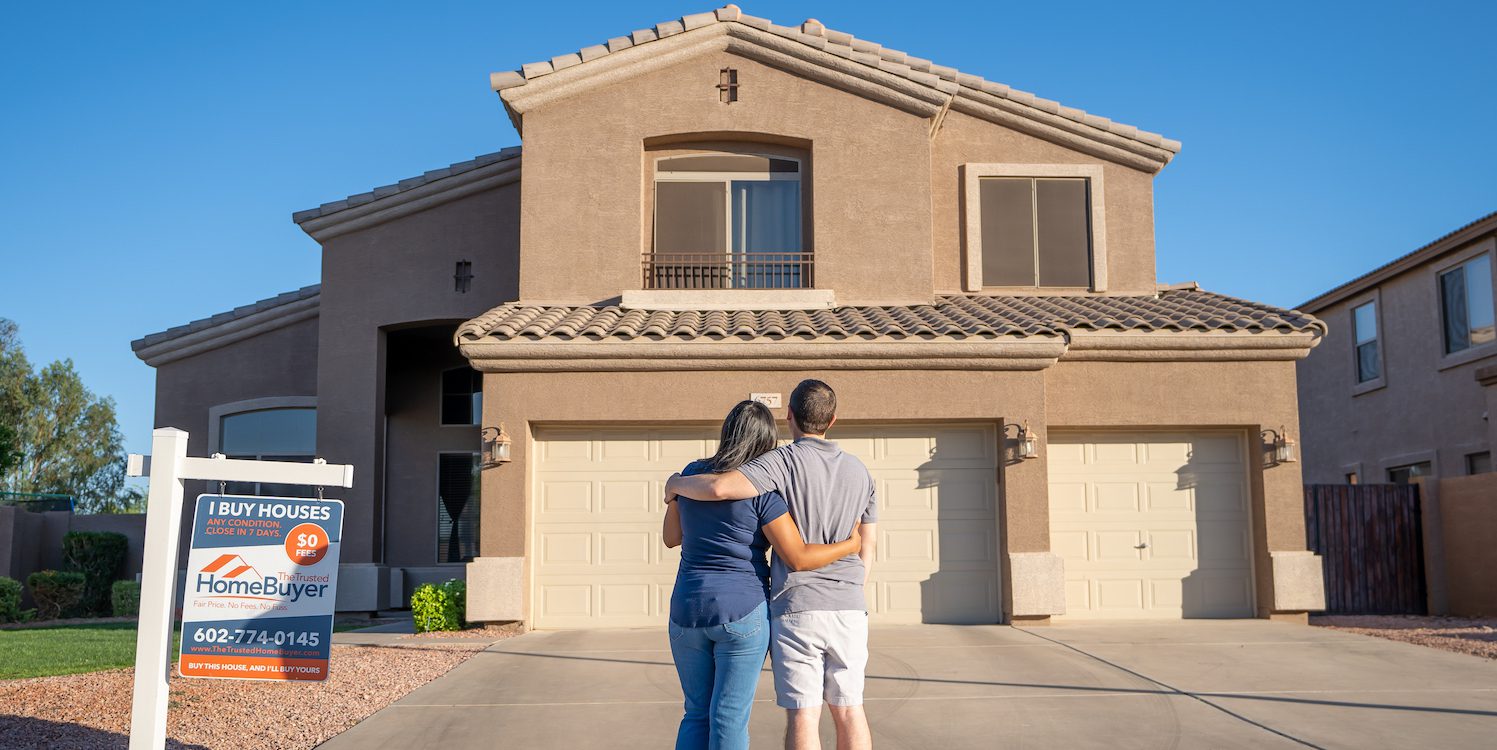 Young couple embracing after buying a house