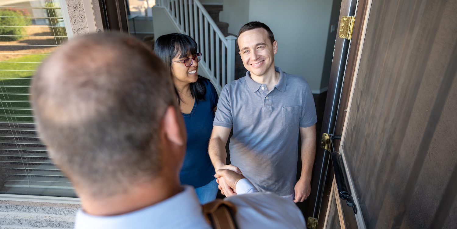 Homebuyer shaking homeowners hand