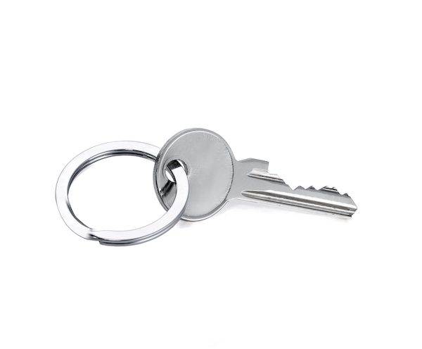Silver key with a white background