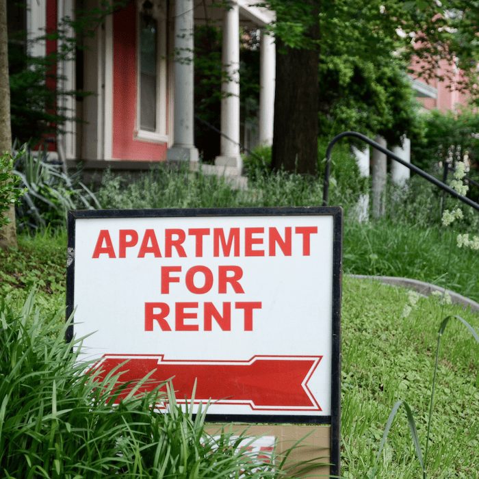 apartment for rent sign in front lawn