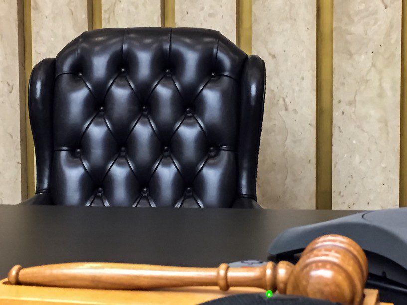 a judges seat with a wooden desk and gavel
